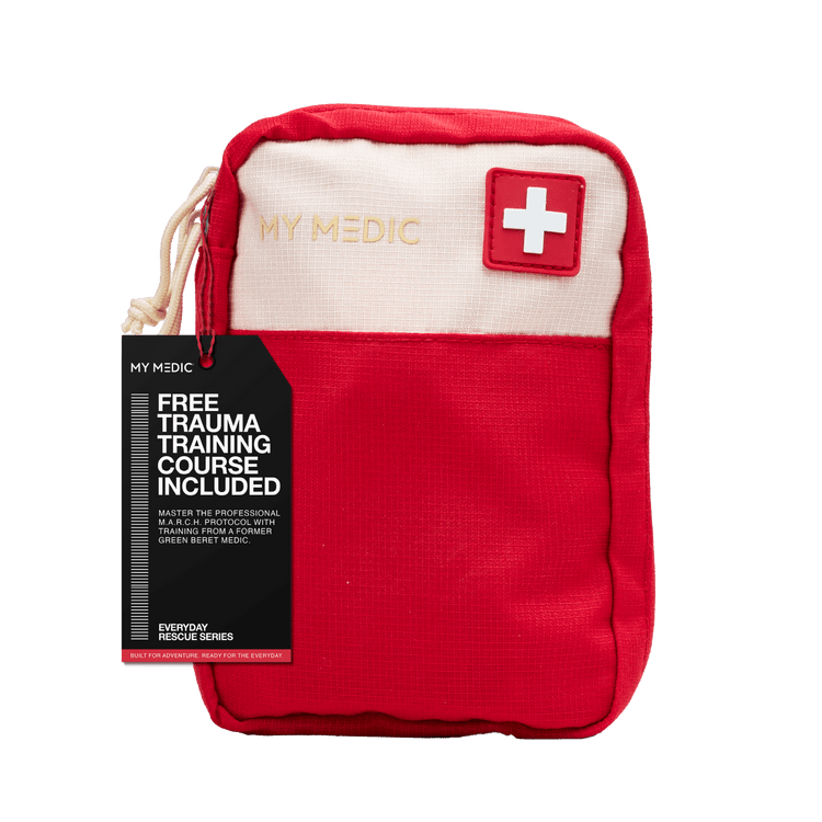A red and off-white My Medic first aid pouch with a black promotional hangtag saying that there is a "Free trauma course included"