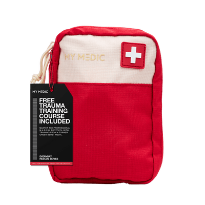 A red and off-white My Medic first aid pouch with a black promotional hangtag saying that there is a "Free trauma course included"