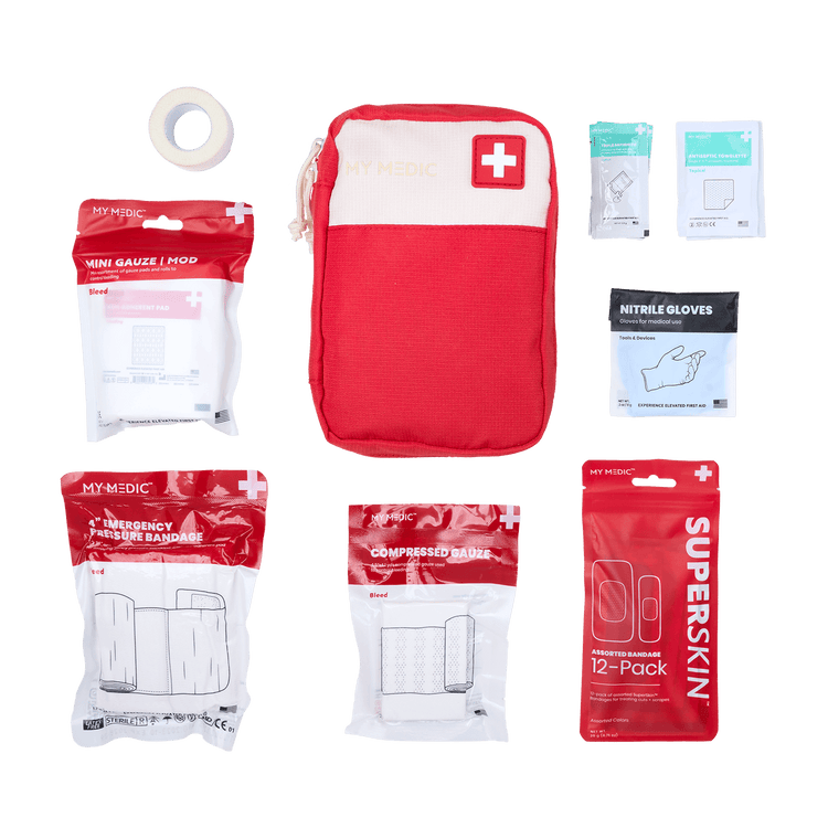 A red and white Bleeding Control first aid kit set from MY MEDIC. The kit includes a mini gauze mod, nitrile gloves, compressed gauze, emergency pressure bandage, a 12-pack of SuperSkin bandages, cloth surgical tape, tripe antibiotic ointment, and antiseptic towelettes.