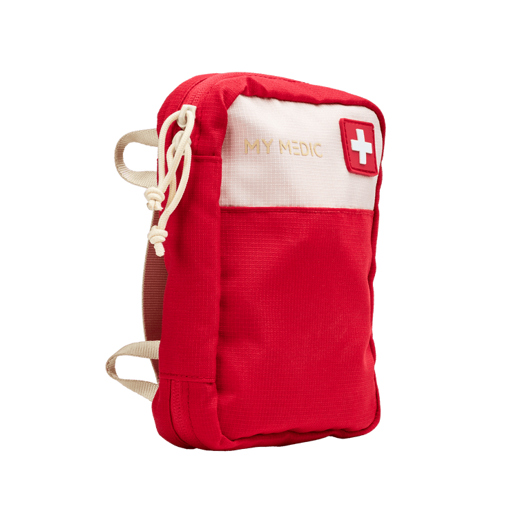 A red and off-white first aid pouch with 'MY MEDIC' printed on the front and a Swiss cross symbol, shown on a plain white background.