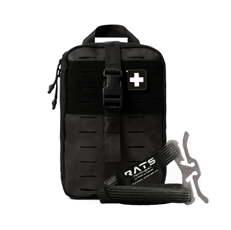 Black tactical first aid kit pouch with a front buckle strap, a white medical cross patch, and a black emergency tourniquet