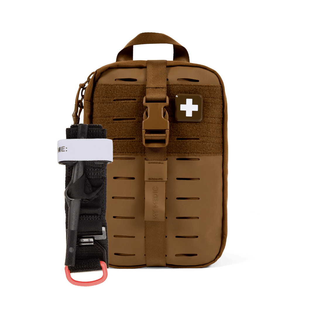 A brown tactical first aid kit pouch with a quick-release buckle and a white cross patch, shown alongside a black emergency tourniquet with a red carabiner clip and white band.
