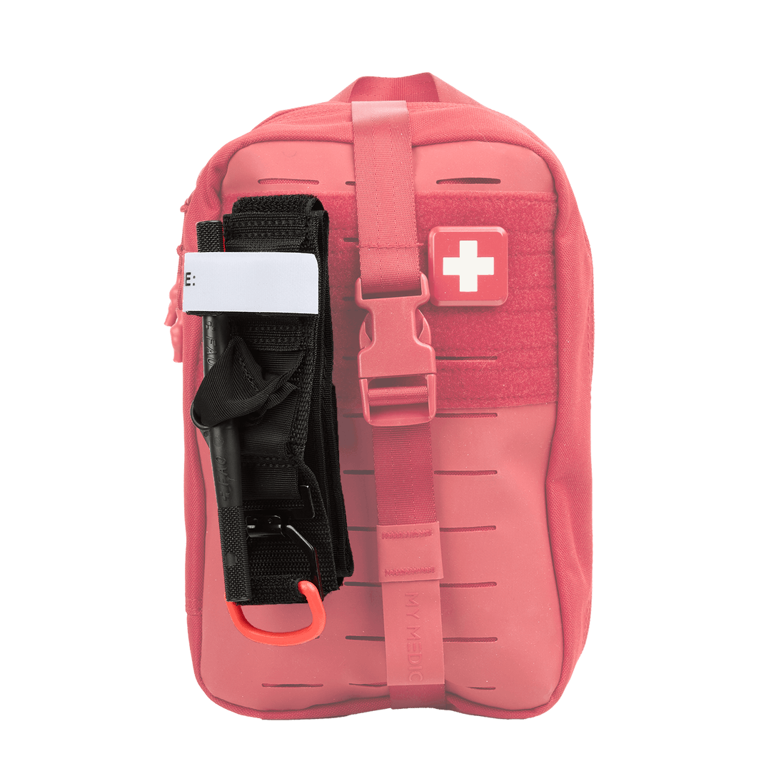 A red medical kit featuring a black tourniquet attached on the side, set against a plain white background.
