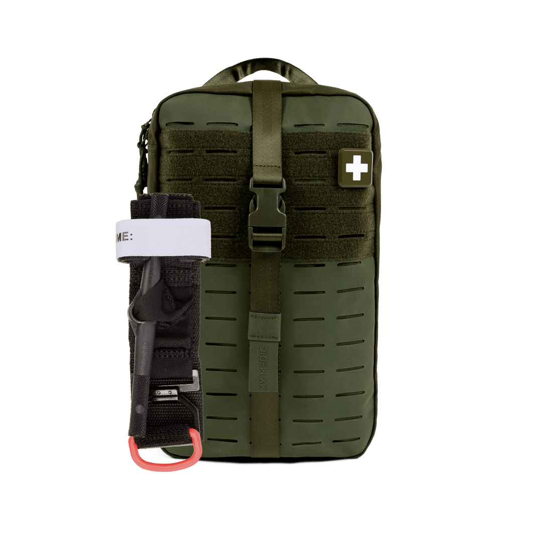 An olive green tactical first aid pouch with a front buckle closure and a white cross patch, shown with a black and white emergency windlass tourniquet attached on the left side.