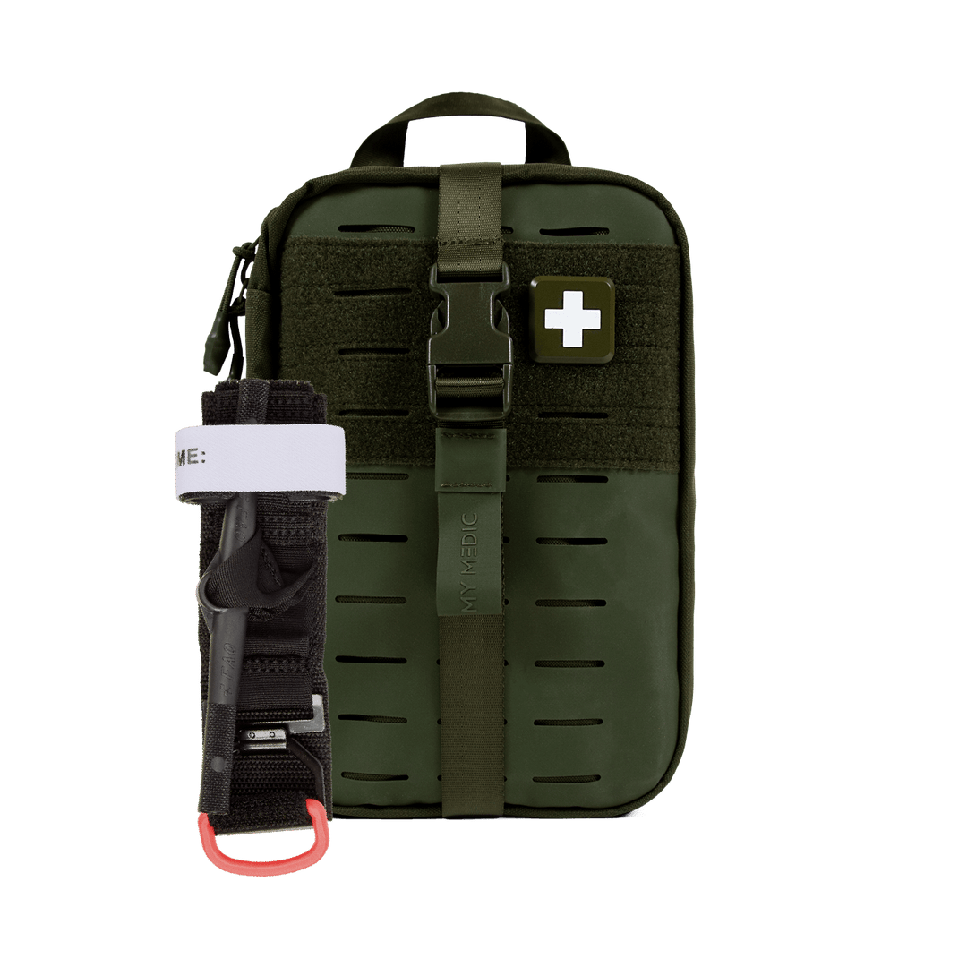 An olive green tactical first aid pouch with a quick-release buckle strap and a white cross patch, shown alongside a black tourniquet.