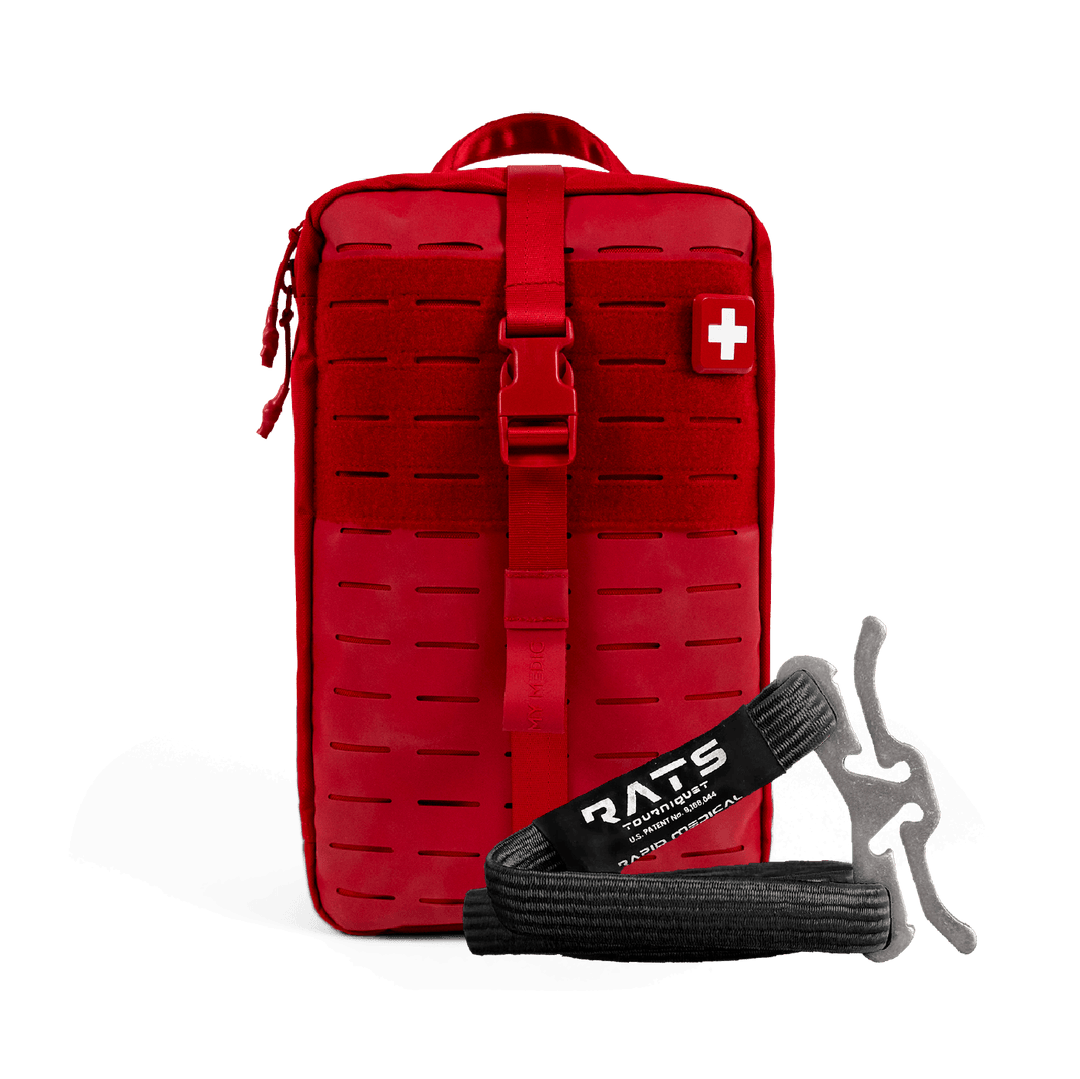 A red tactical first aid kit pouch with a front buckle strap and a white cross patch, shown on a black background with a black and gray RATS emergency tourniquet in front.