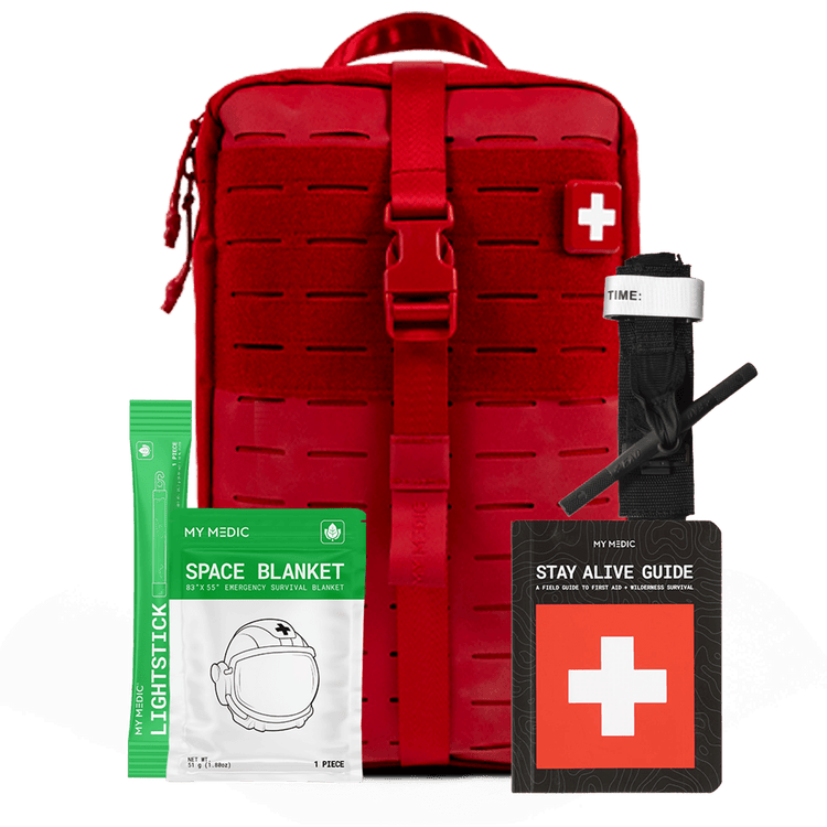 Red MOLLE webbing first aid kit shown with included survival and first aid items on a transparent background: a green My Medic space blanket packet, a black Stay Alive Guide booklet, a black windlass tourniquet and a green lightstick